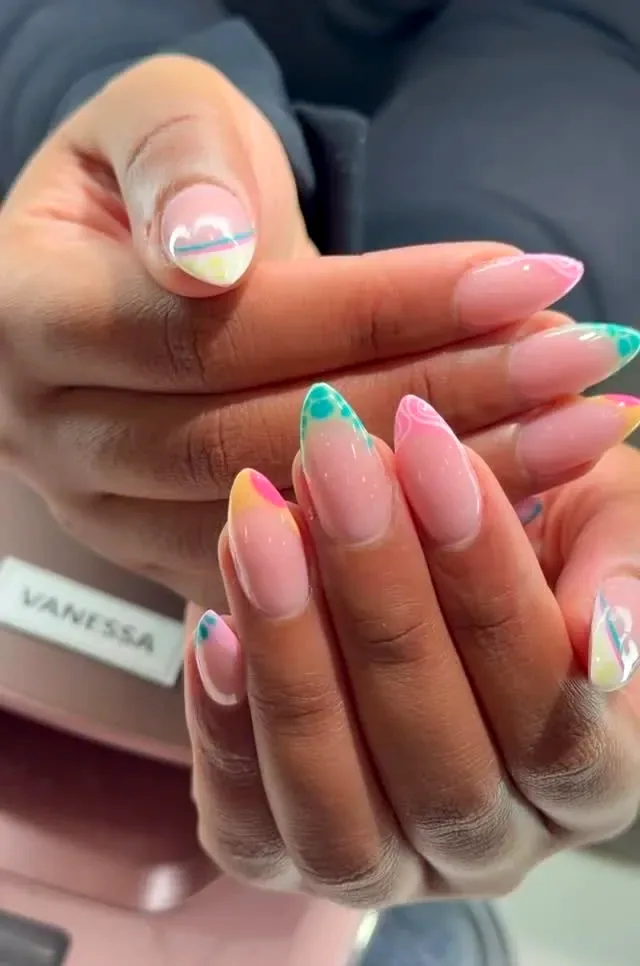 Pastel multicolor French tips on almond nails at Numii Nail Spa